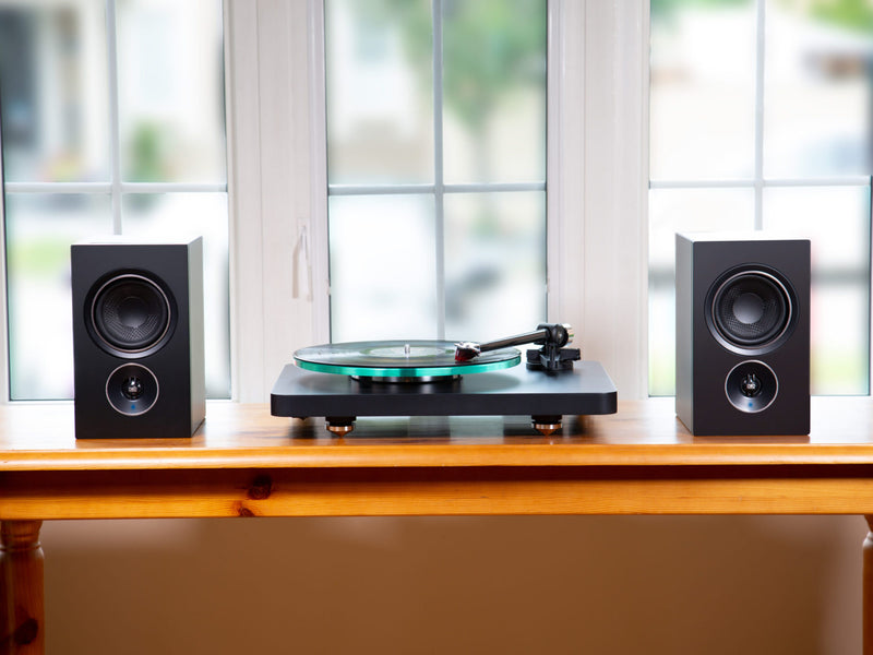 Alpha iQ Black with turntable in front of window
