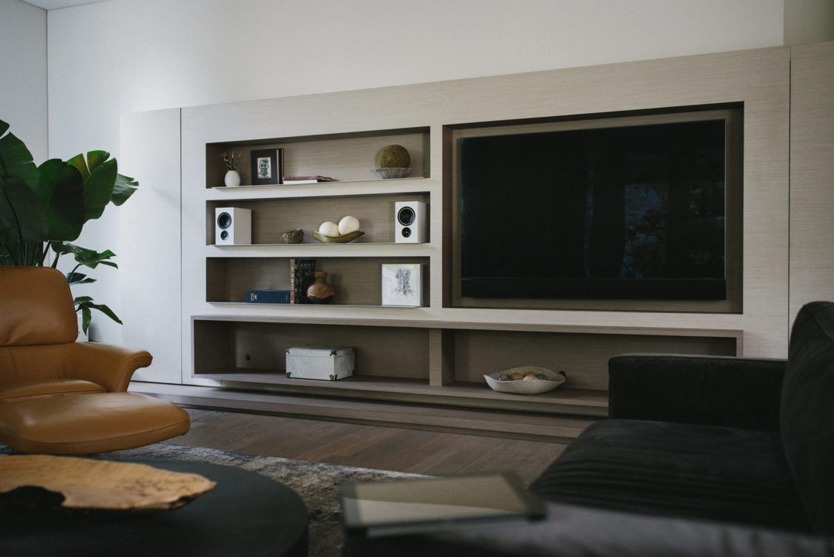 Alpha iQ Speakers on a shelf