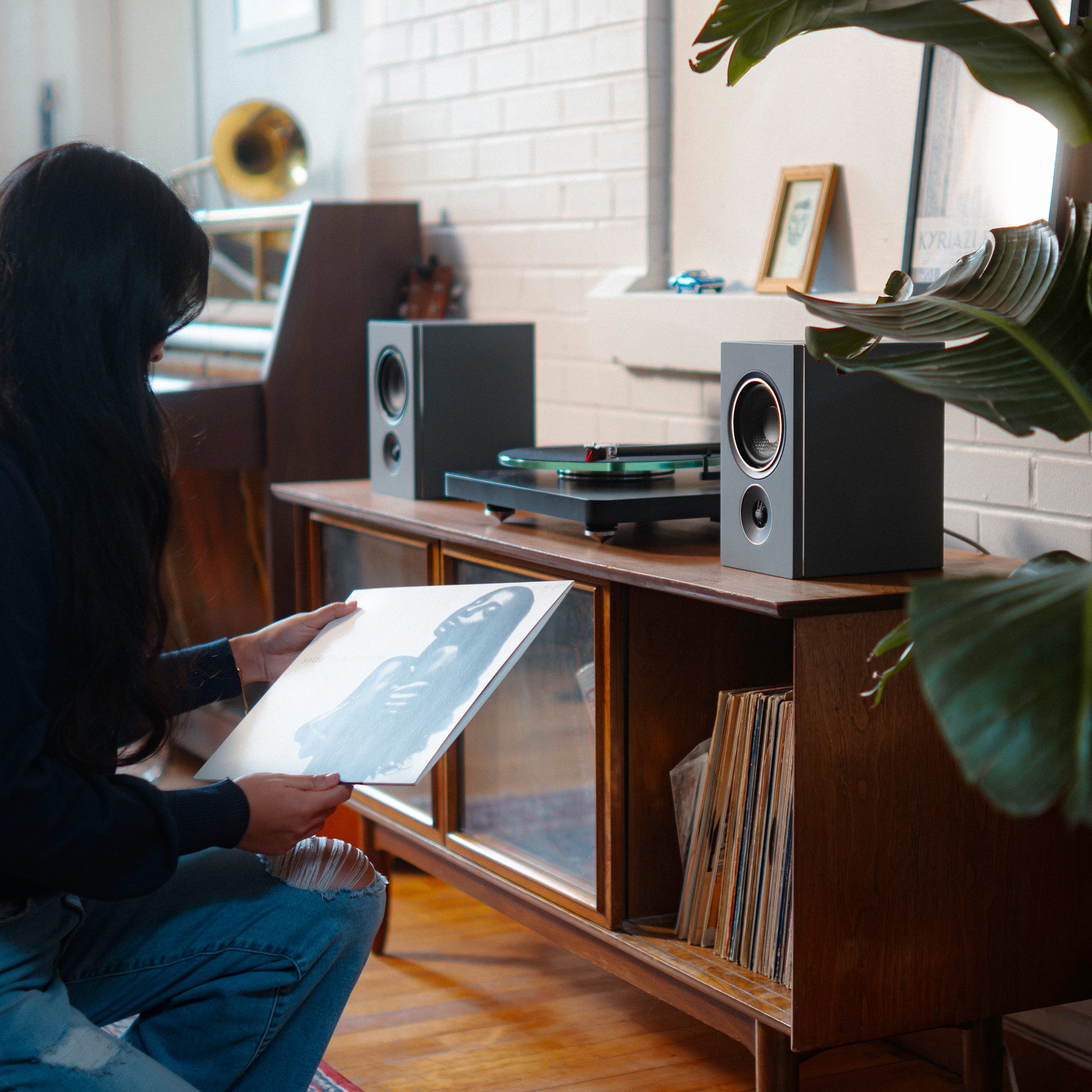 Powered Wireless speakers connected to a turntable playing vinyl records 