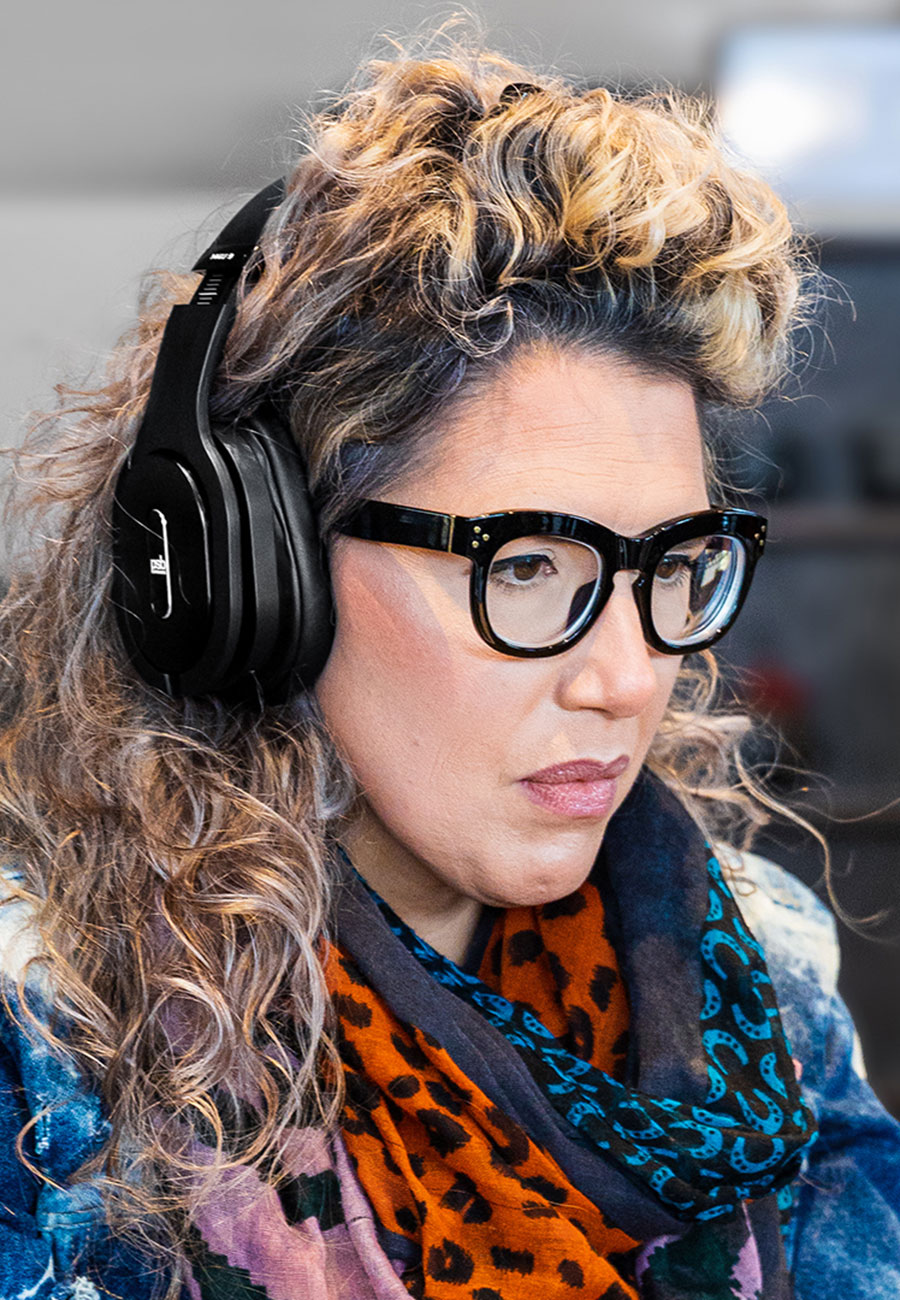 A woman listening on a PSB M4U 9 headphone.