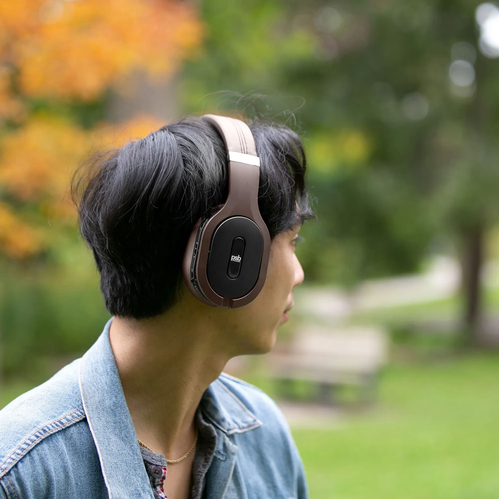 A man outdoors wearing the M4U 8 MKII headphones