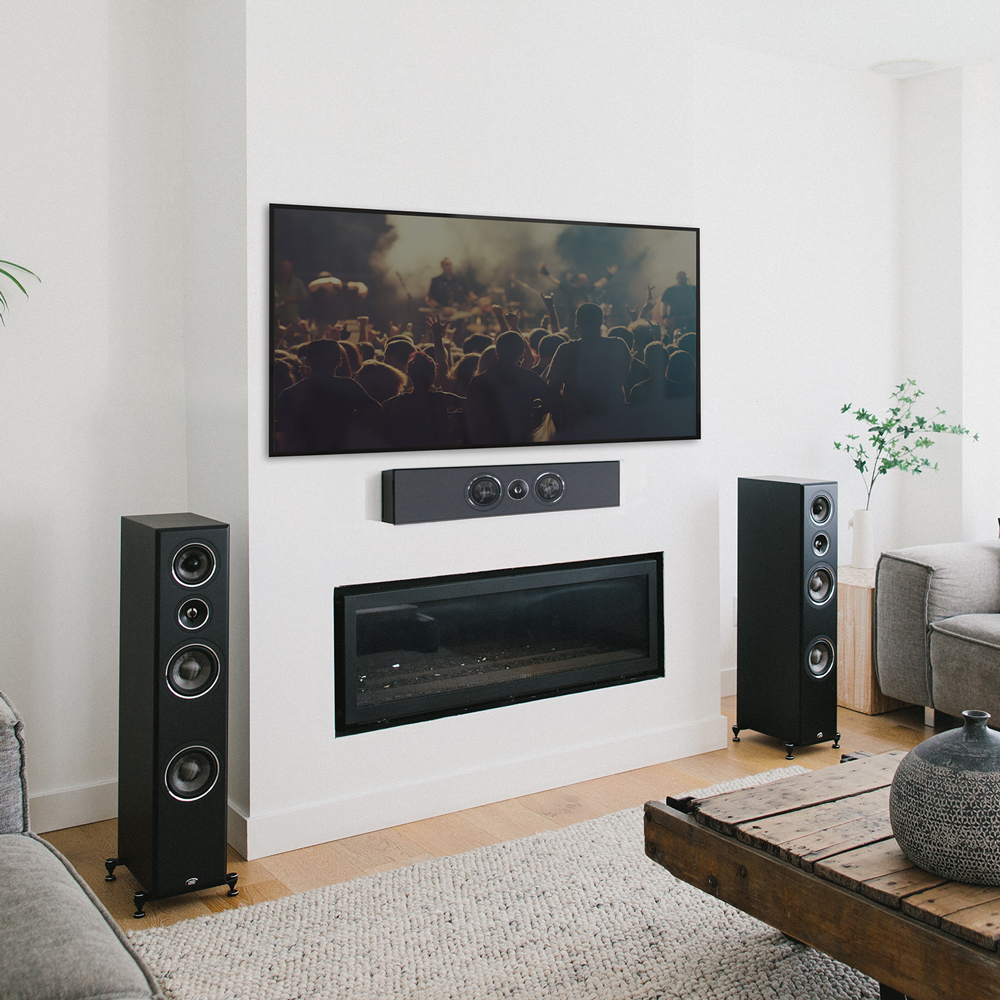 A black PWM1 on-wall speaker mounted horizontally below a TV