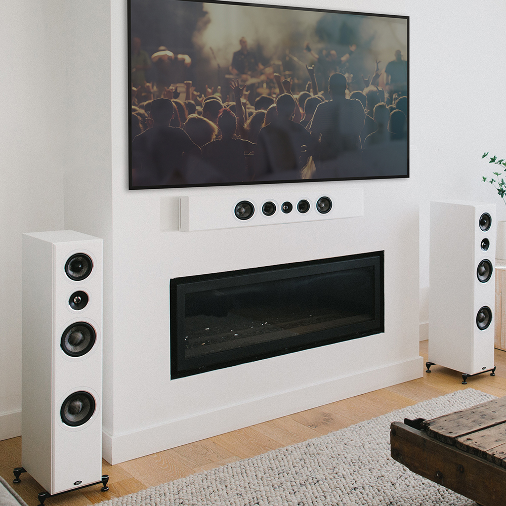A white PWM2 mounted on a wall horizontally below a TV