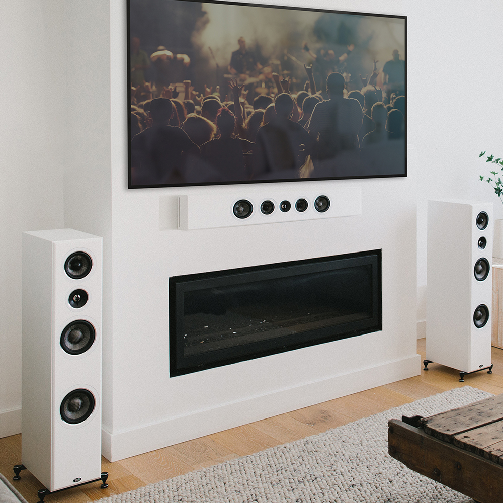 A white PWM2 mounted on a wall horizontally below a TV