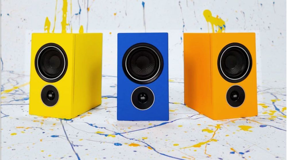 Tangerine Yellow, Midnight Blue and Dutch Orange Alpha iQ speakers in paint splatter environment.