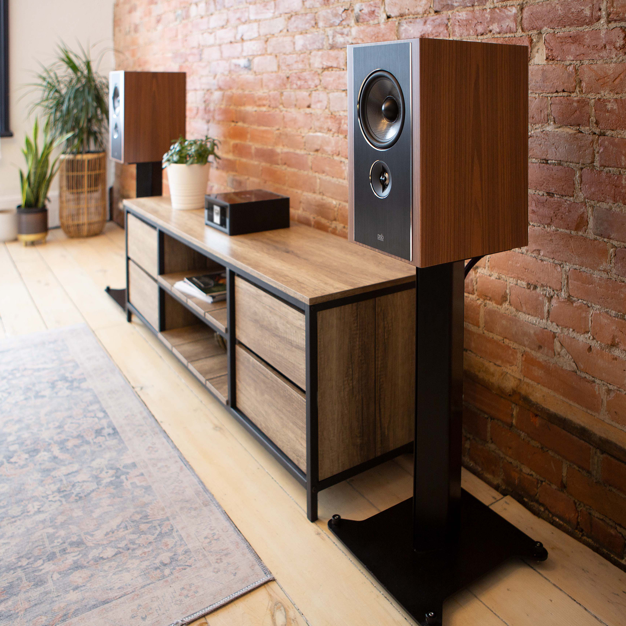 Two Synchrony B600 Bookshelf speakers on stands in a room